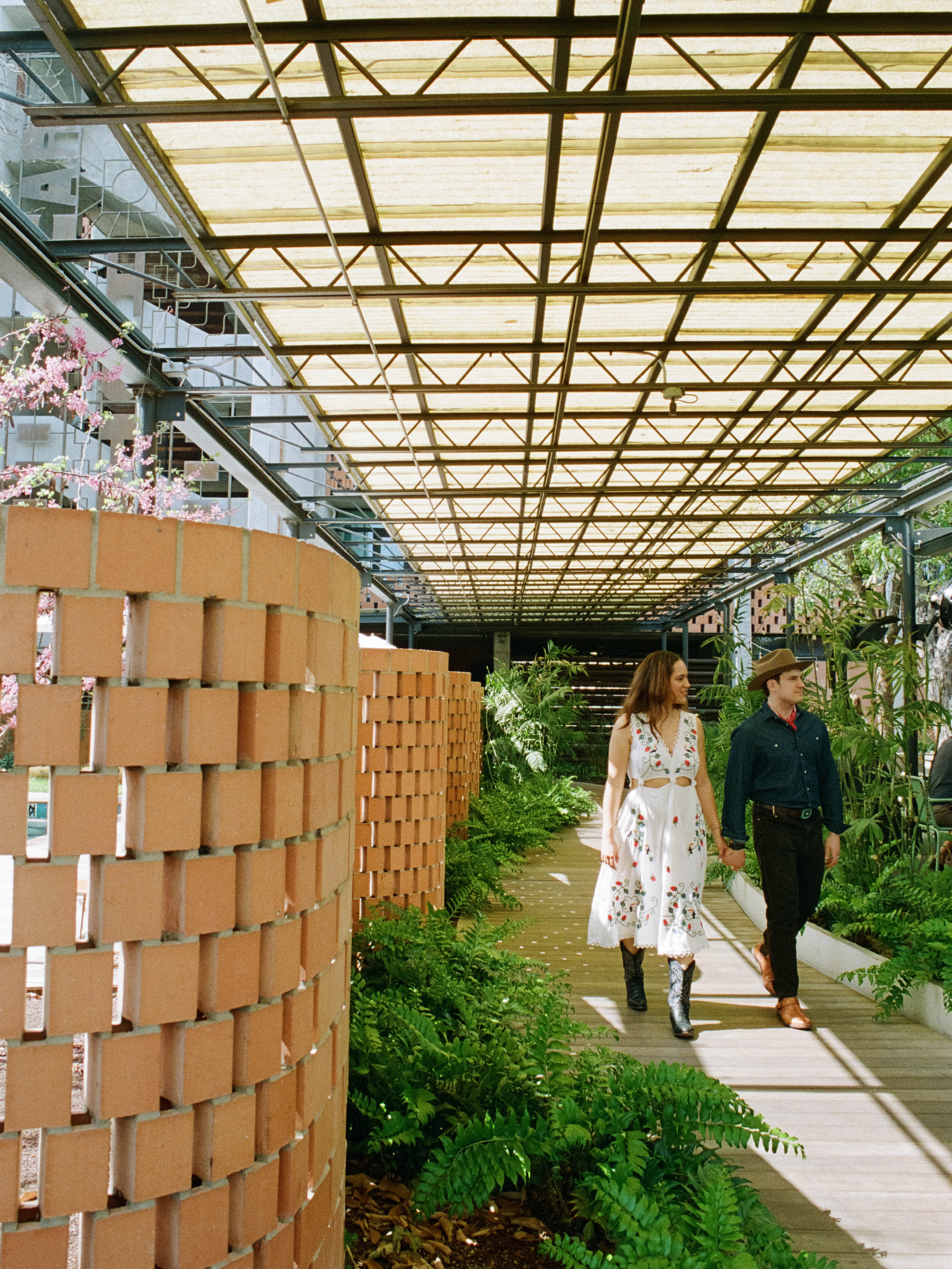Couple walking down breezeway at The Carpenter Hotel in Austin, Texas
