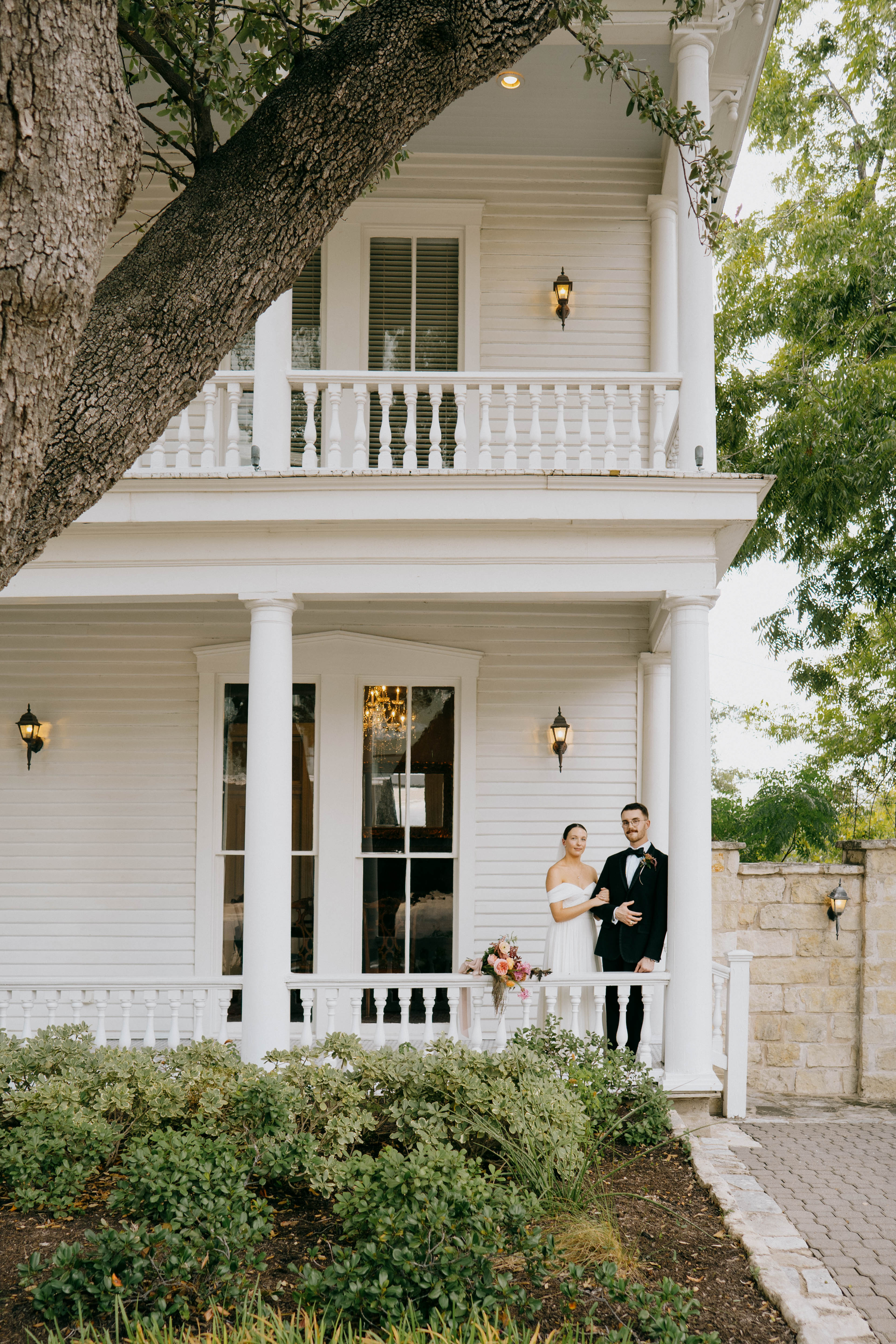 Bride and groom standing on porch at Allan House in Austin, Texas